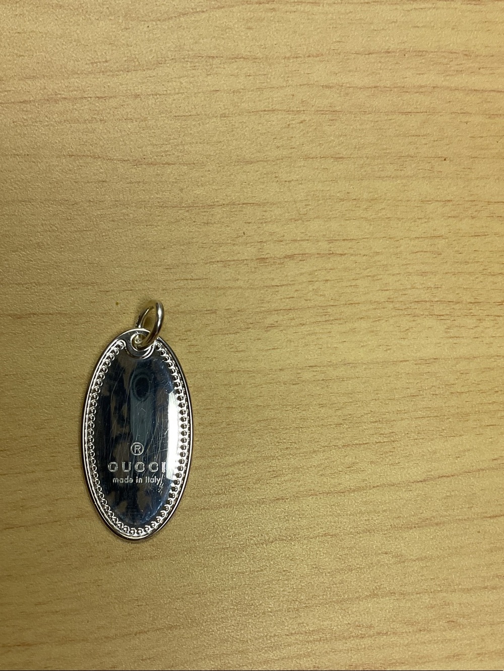 Gucci Silver-Tone Oval Logo Pendant Charm